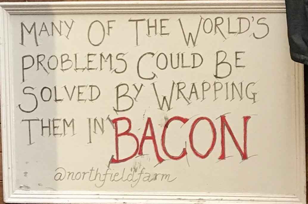 Hand-drawn sign advertising Northfield Farm’s bacon, photo Twitter2019